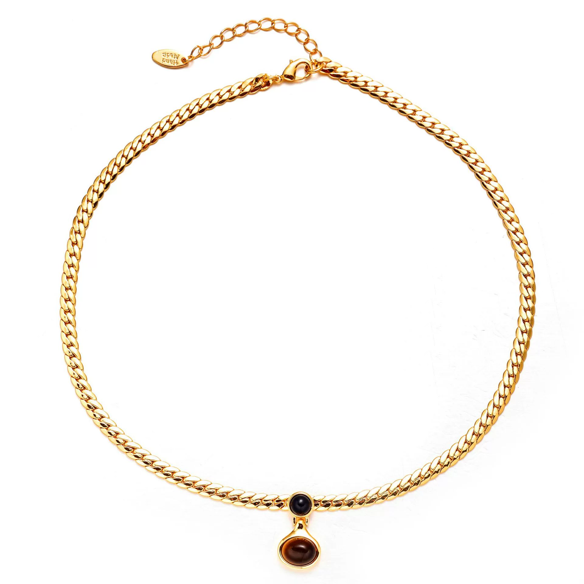 livke-18k-gold-tiger-eye-snake-chain-necklace.jpg LIVKE’s gold tiger eye oval pendant on a snake chain, styled with a linen dress for boho-chic everyday elegance.