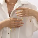 LIVKE’s vintage genuine pearl necklace with 18K gold-plated chain, styled with a black silk dress for timeless elegance.