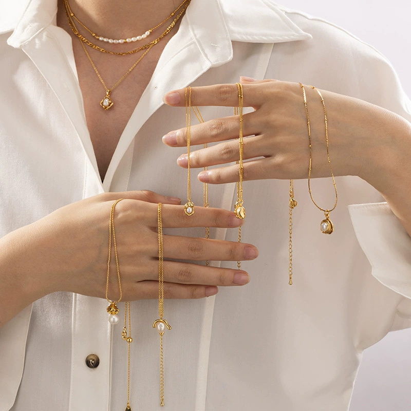 LIVKE’s vintage genuine pearl necklace with 18K gold-plated chain, styled with a black silk dress for timeless elegance.
