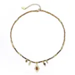 LIVKE’s oval tiger eye necklace with 18K gold-plated chain, styled with black sweater for minimalist elegance.
