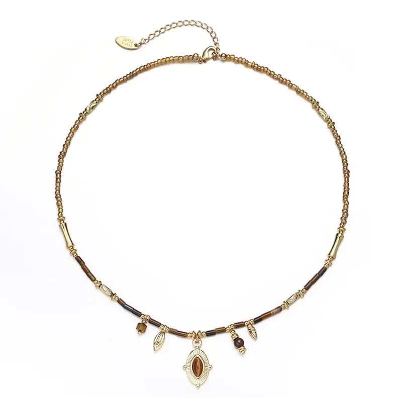 LIVKE’s oval tiger eye necklace with 18K gold-plated chain, styled with black sweater for minimalist elegance.