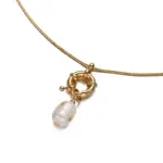 English: “Close-up of LIVKE’s 18K gold plated oval bead necklace in vintage palace style, styled elegantly on a model.”