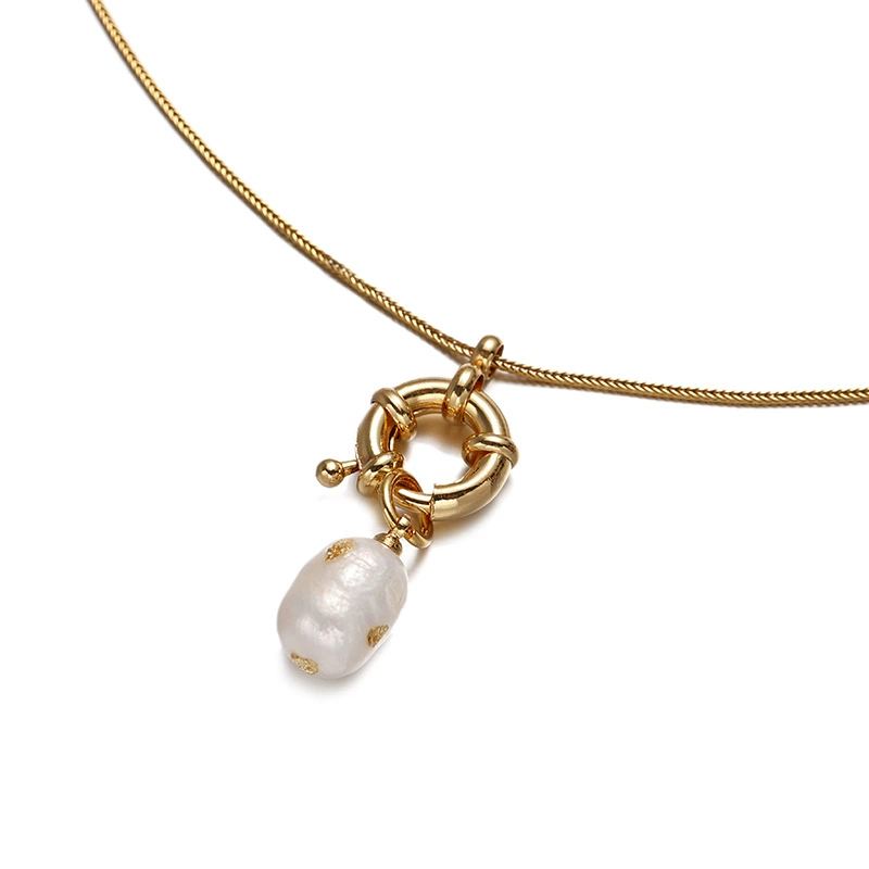 English: “Close-up of LIVKE’s 18K gold plated oval bead necklace in vintage palace style, styled elegantly on a model.”