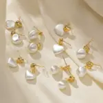 LIVKE’s vintage heart stud earrings with textured gold finish, styled with a denim jacket for casual-chic outfits.