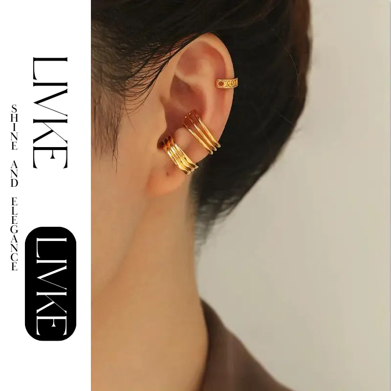 LIVKE’s gold openwork ear cuff styled on a helix, paired with minimalist hoops for edgy everyday elegance.