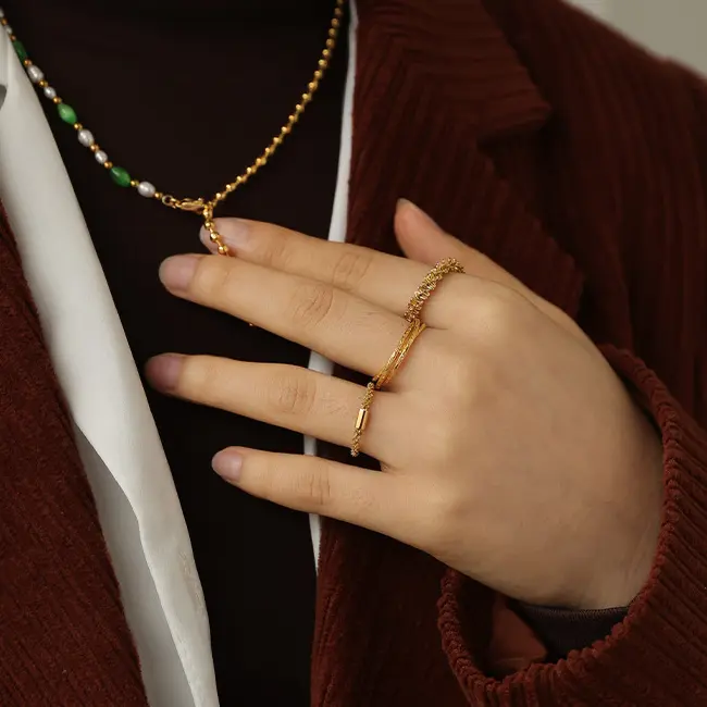 LIVKE’s 18K PVD gold minimalist ring stacked with raw-edge bands for modern gender-neutral style.