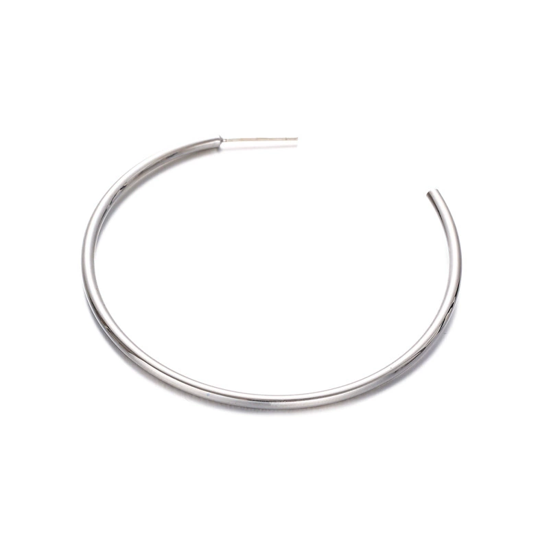 LIVKE’s minimalist sterling silver hoop earrings styled with a white button-up for office-ready elegance.