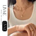 LIVKE’s gold layered heart necklaces styled with a black turtleneck for minimalist everyday elegance.