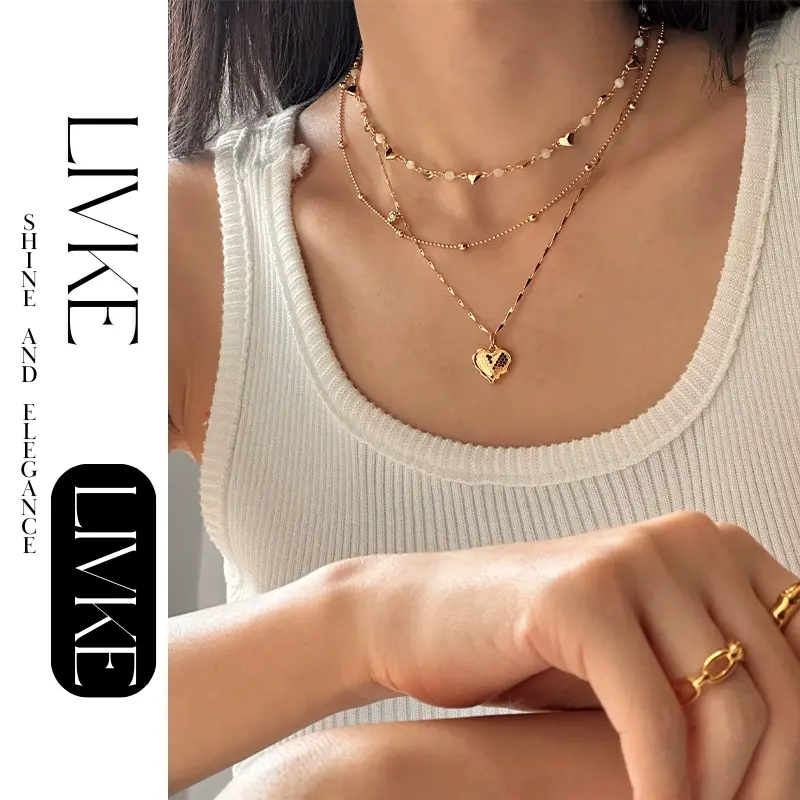 LIVKE’s gold layered heart necklaces styled with a black turtleneck for minimalist everyday elegance.