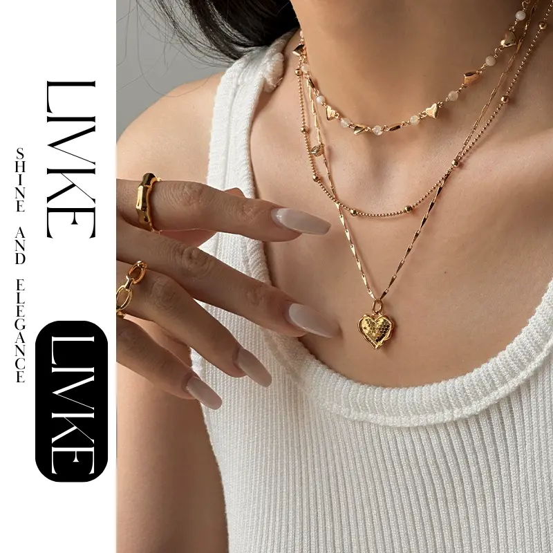 LIVKE’s gold layered heart necklaces styled with a black turtleneck for minimalist everyday elegance.