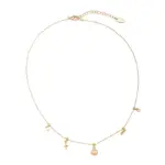 LIVKE’s gold summer wave necklace with shell and zirconia pendant, styled with a straw hat for beachside elegance.