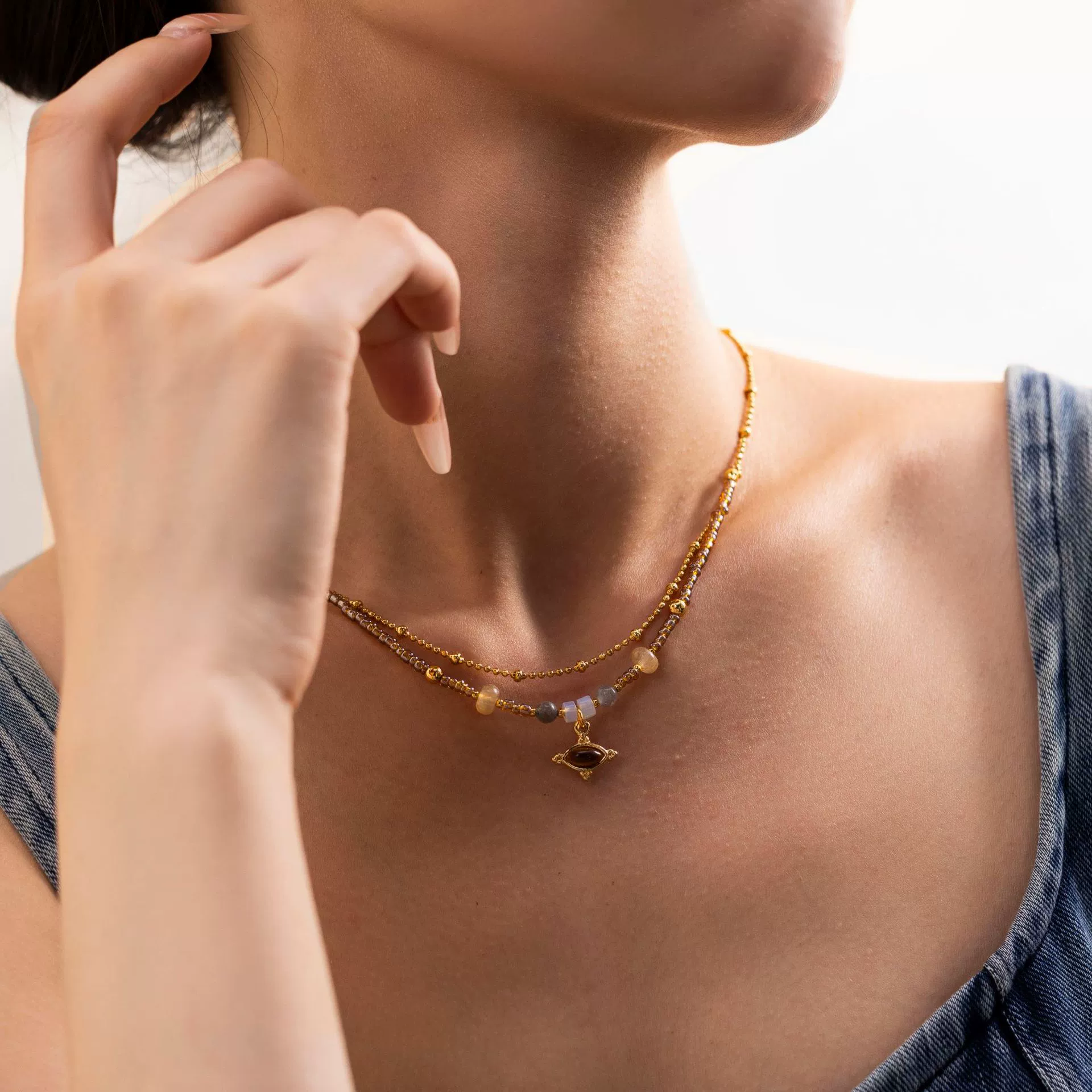 livke-tiger-eye-bead-gold-necklace (2) LIVKE’s tiger eye bead necklace with gold and zirconia accents, styled with a linen dress for boho everyday elegance.