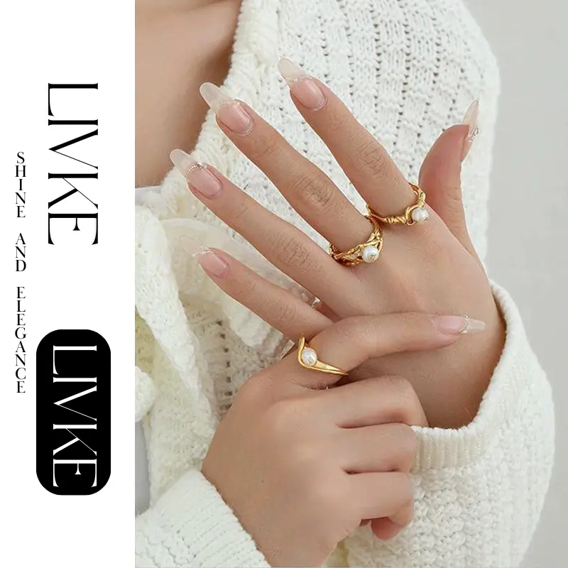 LIVKE’s gold leaf and pearl adjustable ring on a hand with neutral nails, styled with a linen dress for effortless boho elegance.