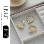 LIVKE’s gold leaf and pearl adjustable ring on a hand with neutral nails, styled with a linen dress for effortless boho elegance.