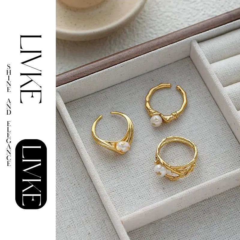 LIVKE’s gold leaf and pearl adjustable ring on a hand with neutral nails, styled with a linen dress for effortless boho elegance.