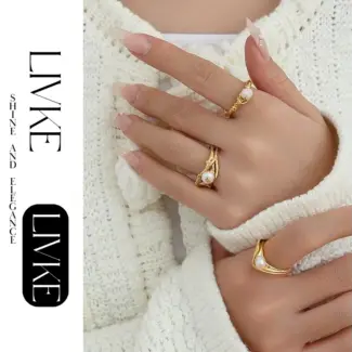 LIVKE’s gold leaf and pearl adjustable ring on a hand with neutral nails, styled with a linen dress for effortless boho elegance.
