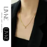 LIVKE’s gold-plated square zircon pendant necklace styled with a white silk blouse for timeless elegance.