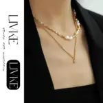 LIVKE’s gold-plated square zircon pendant necklace styled with a white silk blouse for timeless elegance.