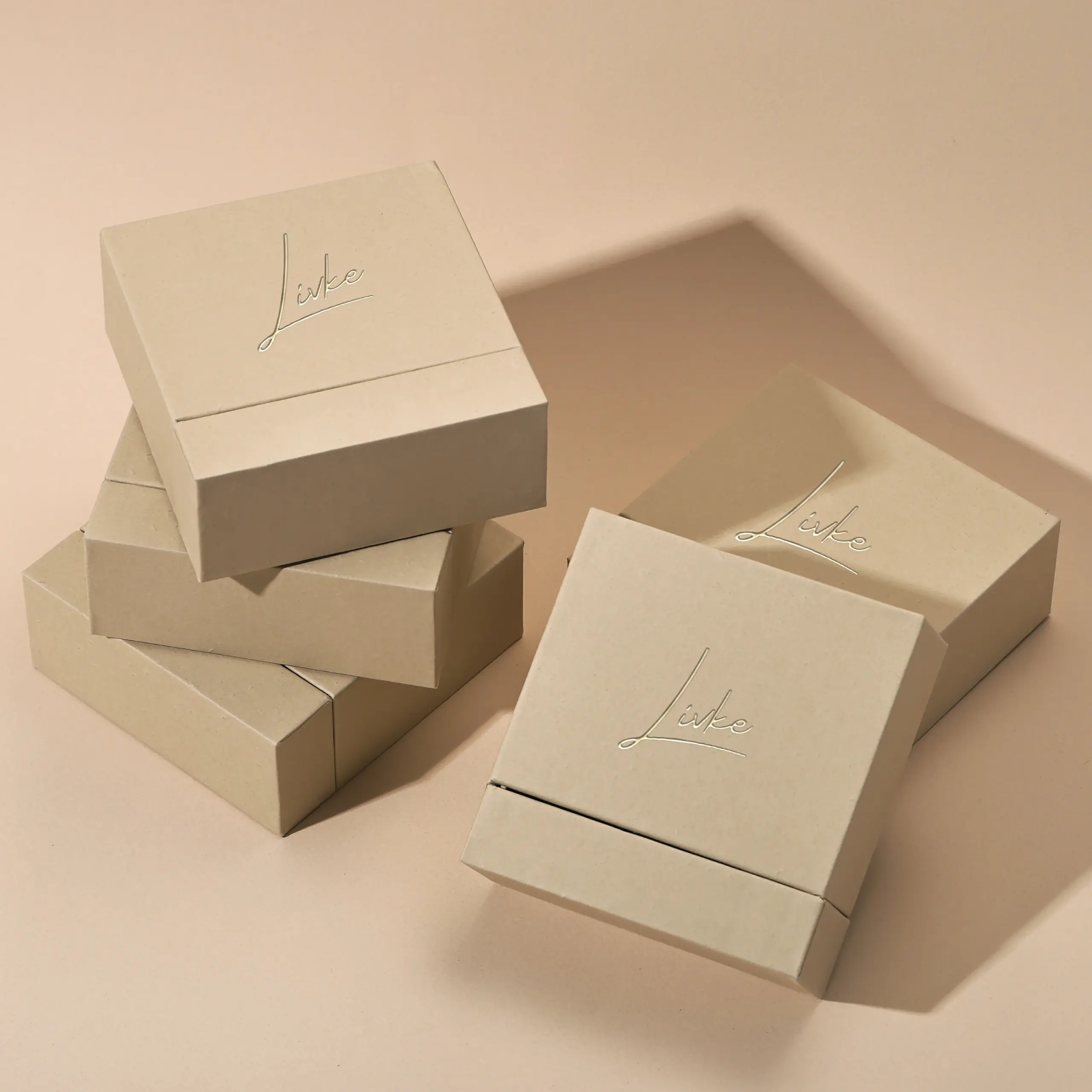 gold-foil-jewelry-care-set-flatlay (5) Beige drawer box open with polishing cloth, necklace and ring on velvet background