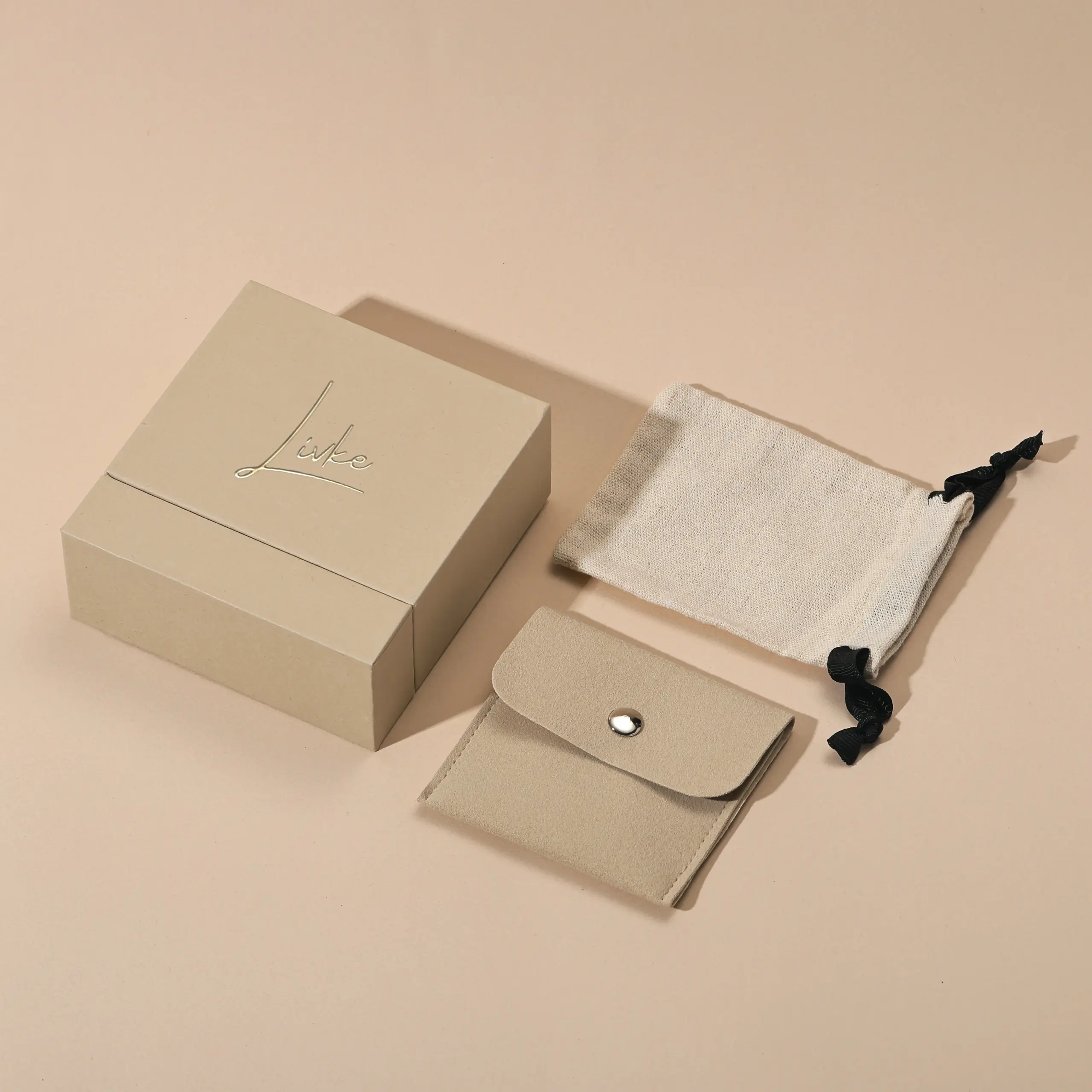 gold-foil-jewelry-care-set-flatlay (6) Beige drawer box open with polishing cloth, necklace and ring on velvet background