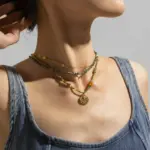 Adjustable LIVKE brass necklace with amethyst and turquoise beads layered over linen dress for bohemian everyday style.
