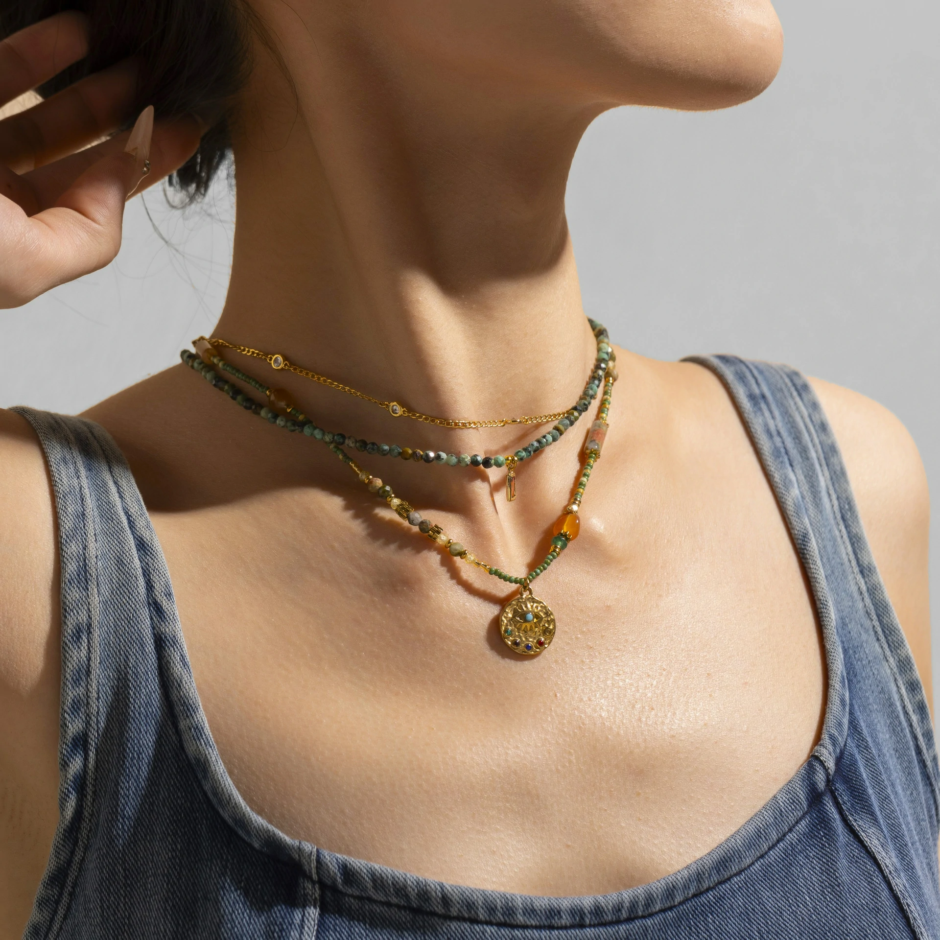 livke-18k-gold-natural-stone-necklace-layered-boho (3) Adjustable LIVKE brass necklace with amethyst and turquoise beads layered over linen dress for bohemian everyday style.