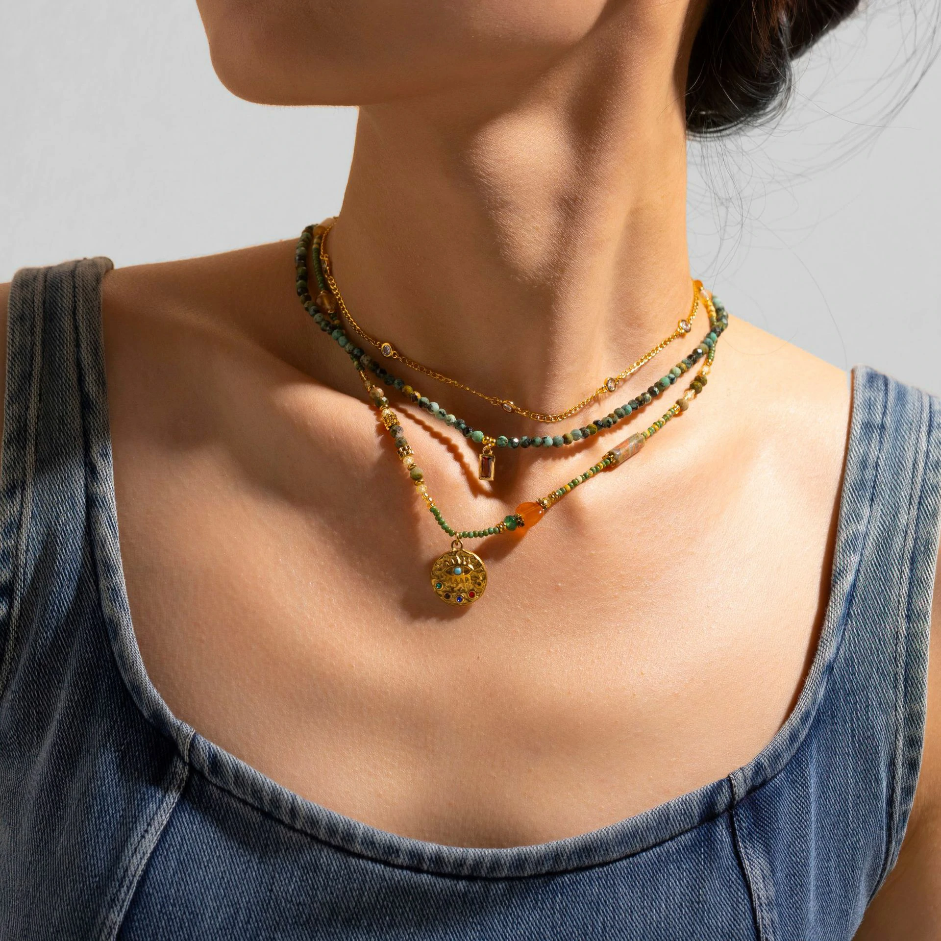 livke-18k-gold-natural-stone-necklace-layered-boho (5) Adjustable LIVKE brass necklace with amethyst and turquoise beads layered over linen dress for bohemian everyday style.