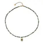 Adjustable LIVKE brass necklace with amethyst and turquoise beads layered over linen dress for bohemian everyday style.