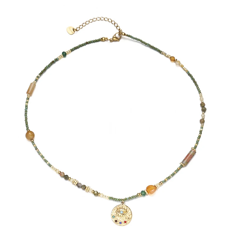 Adjustable LIVKE brass necklace with amethyst and turquoise beads layered over linen dress for bohemian everyday style.