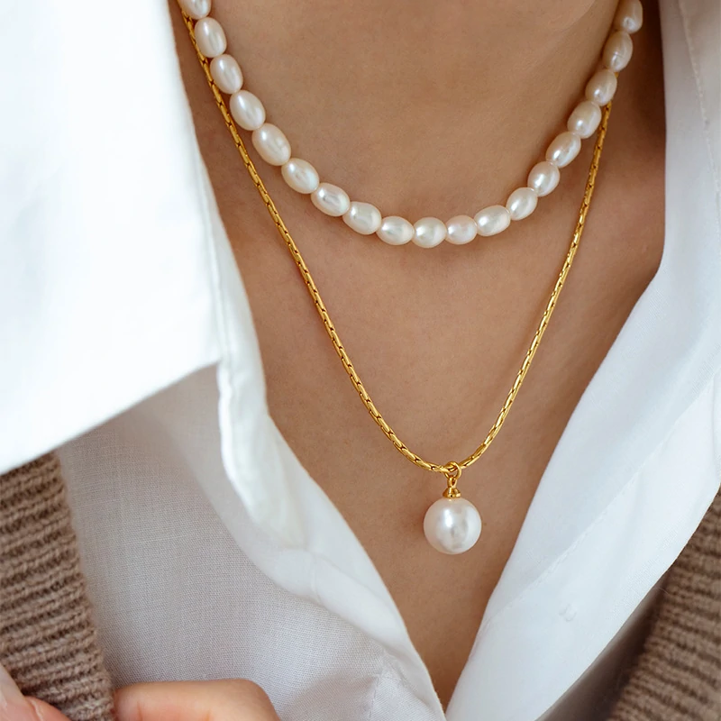 Woman wearing LIVKE braided gold chain pearl necklace with tailored blouse, showcasing minimalist office jewelry