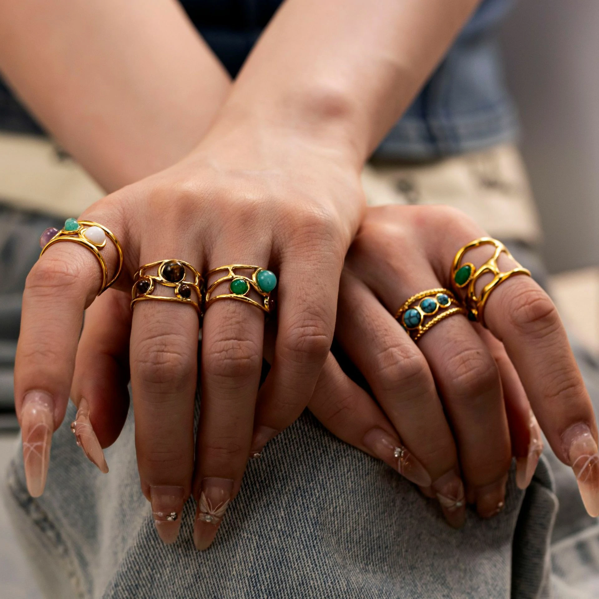 Hand wearing LIVKE triple-layered titanium ring with natural stone inlay during business meeting and cocktail party, showcasing versatile power jewelry