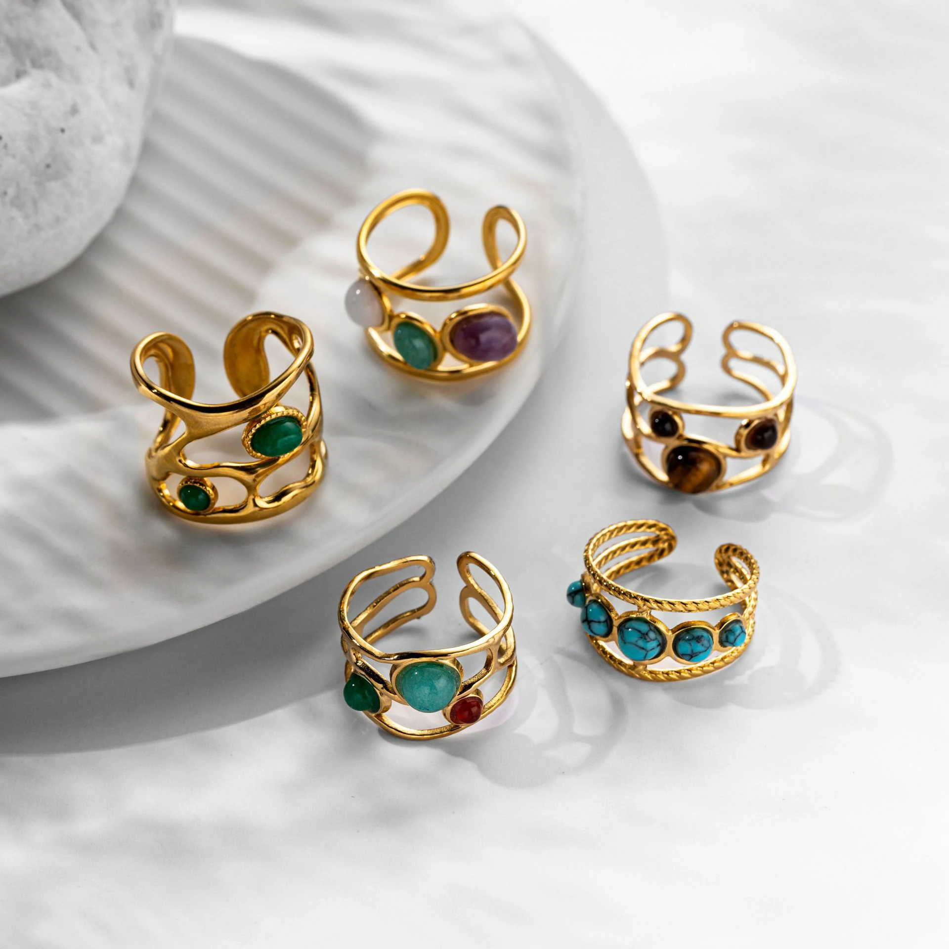 Hand wearing LIVKE triple-layered titanium ring with natural stone inlay during business meeting and cocktail party, showcasing versatile power jewelry