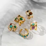 Hand wearing LIVKE triple-layered titanium ring with natural stone inlay during business meeting and cocktail party, showcasing versatile power jewelry