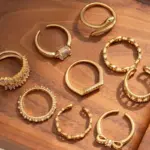 Eclectic woman stacking LIVKE gold textured rings on fingers while browsing vintage market, showcasing bohemian jewelry styling