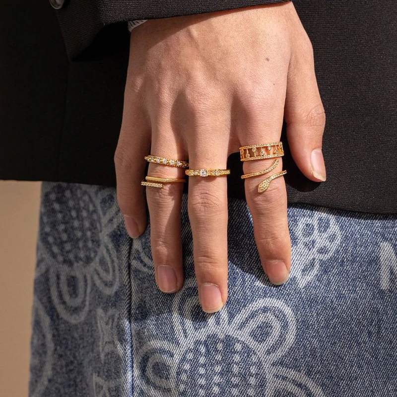 Eclectic woman stacking LIVKE gold textured rings on fingers while browsing vintage market, showcasing bohemian jewelry styling