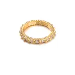 Eclectic woman stacking LIVKE gold textured rings on fingers while browsing vintage market, showcasing bohemian jewelry styling