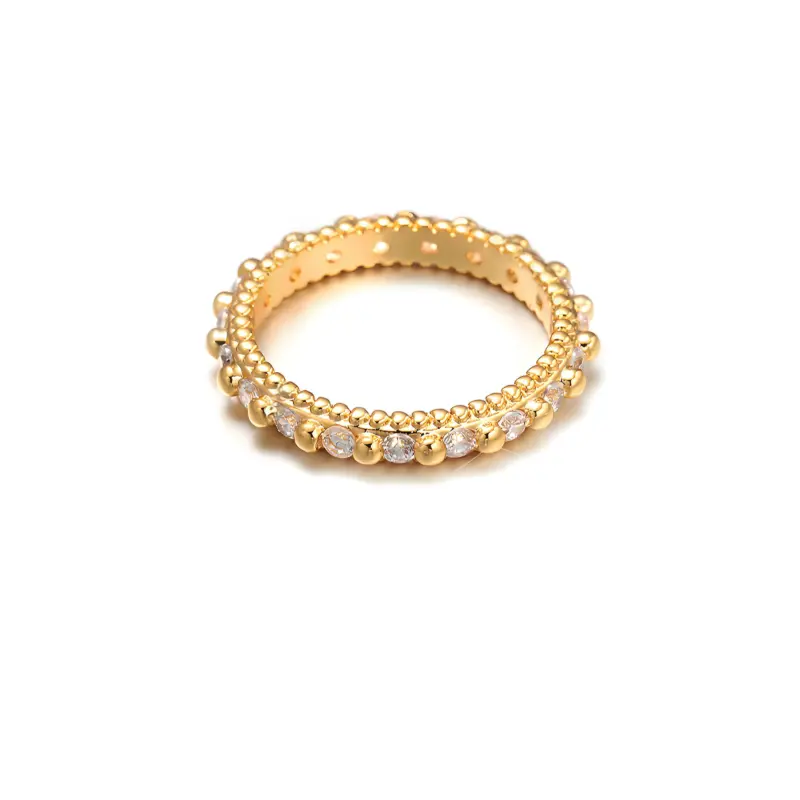 Eclectic woman stacking LIVKE gold textured rings on fingers while browsing vintage market, showcasing bohemian jewelry styling