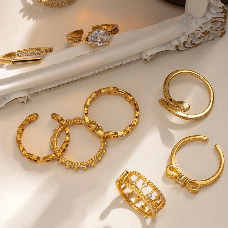 Eclectic woman stacking LIVKE gold textured rings on fingers while browsing vintage market, showcasing bohemian jewelry styling