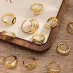 Woman stacking LIVKE textured gold rings with UV color shift effect for TikTok transition video