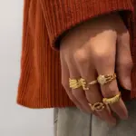 Woman stacking LIVKE textured gold rings with UV color shift effect for TikTok transition video