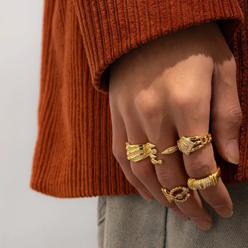 Woman stacking LIVKE textured gold rings with UV color shift effect for TikTok transition video
