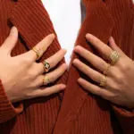 Woman stacking LIVKE textured gold rings with UV color shift effect for TikTok transition video