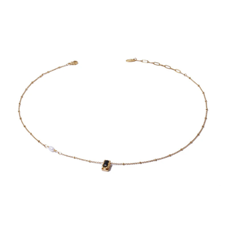 livke-black-cz-pearl-necklace-duo (2) Model wearing LIVKE necklace with black CZ and pearl pendants on collarbone