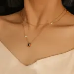 Midnight Pearl Necklace 3 Model wearing LIVKE necklace with black CZ and pearl pendants on collarbone