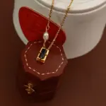 Midnight Pearl Necklace 4 Model wearing LIVKE necklace with black CZ and pearl pendants on collarbone