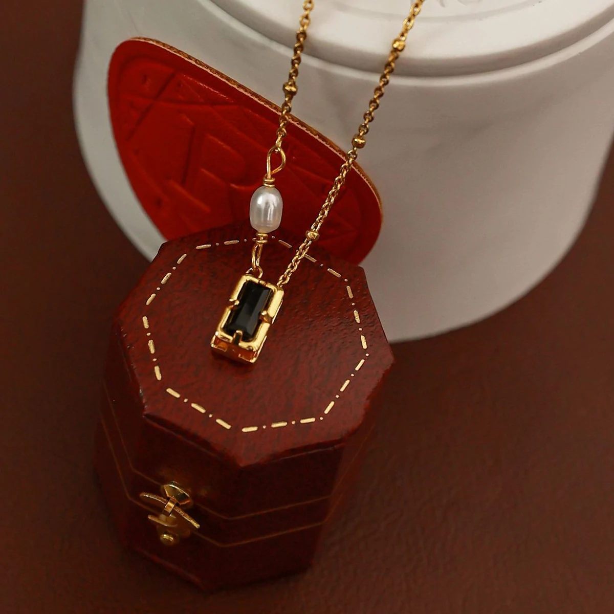 livke-black-cz-pearl-necklace-duo (6) Model wearing LIVKE necklace with black CZ and pearl pendants on collarbone