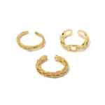 Stacked LIVKE braided and chain rings on hand with bohemian embroidery sleeve, showcasing boho-chic layering.