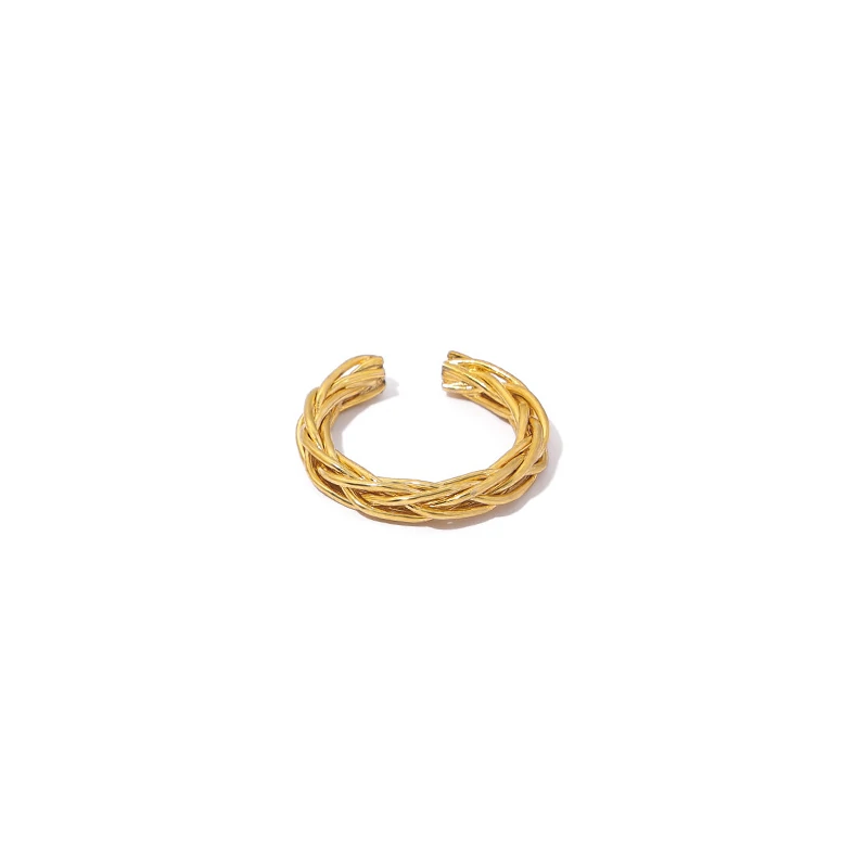 Stacked LIVKE braided and chain rings on hand with bohemian embroidery sleeve, showcasing boho-chic layering.