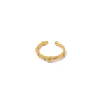 Stacked LIVKE braided and chain rings on hand with bohemian embroidery sleeve, showcasing boho-chic layering.