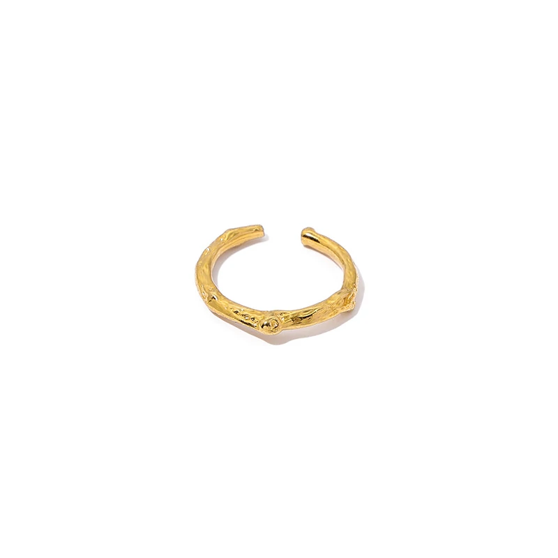 Stacked LIVKE braided and chain rings on hand with bohemian embroidery sleeve, showcasing boho-chic layering.